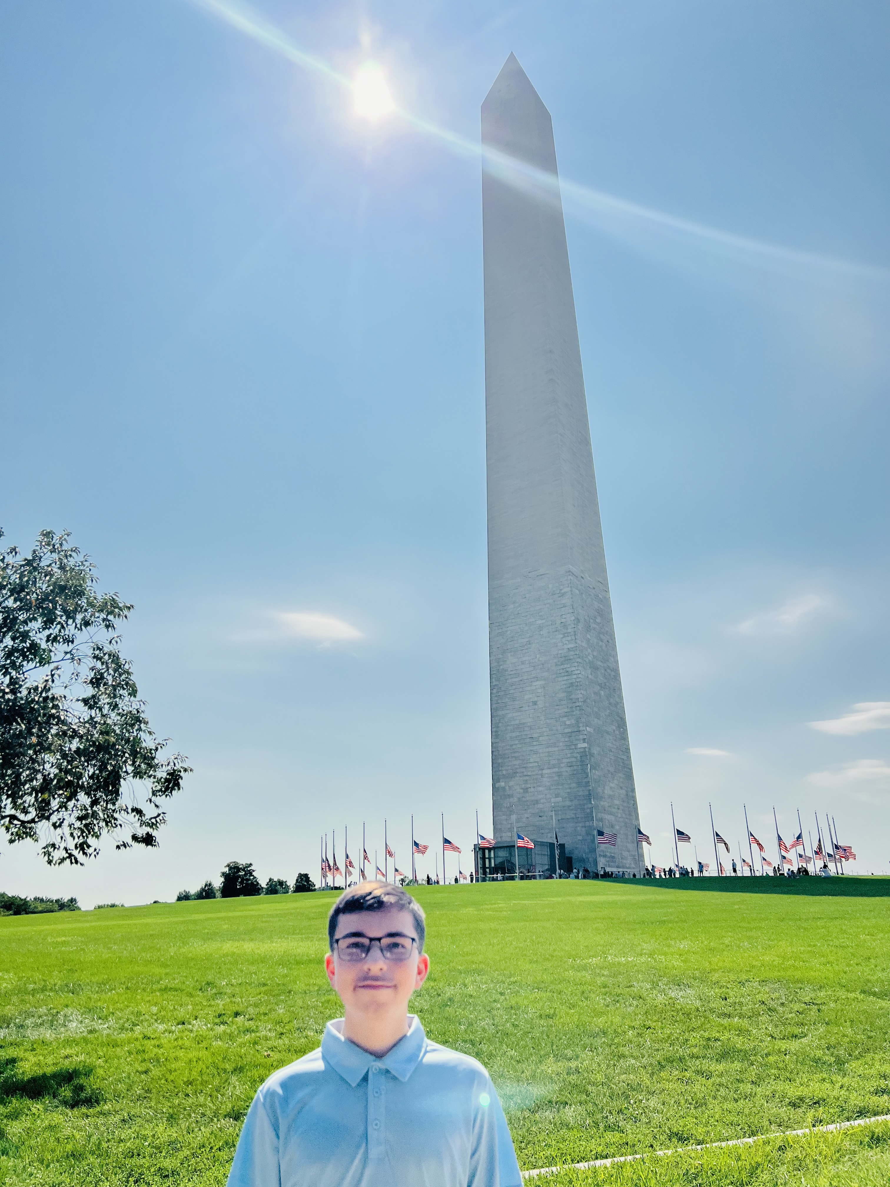 Kingston the young author smiling at the Washington Monument
